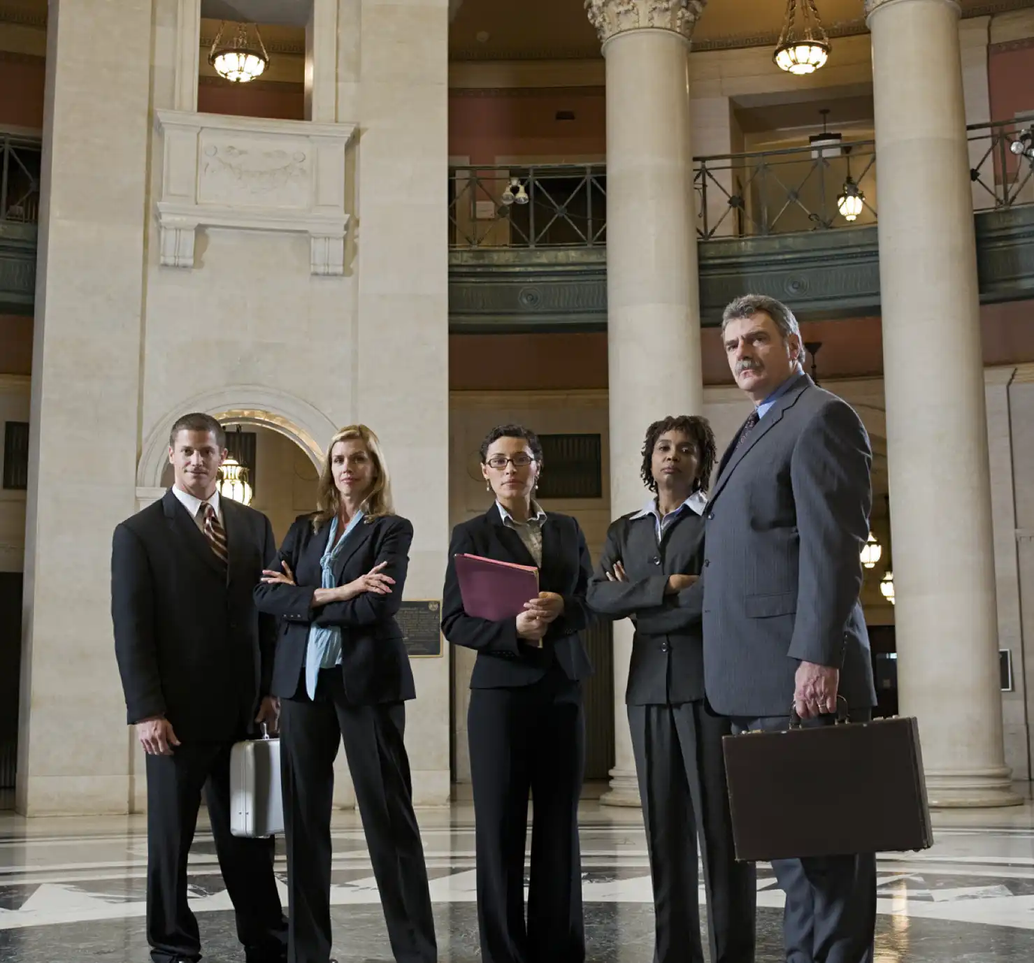 Lawyers standing in a classic courthouse